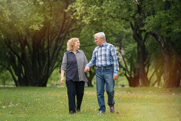 istock Senior couple walking in the park 1311243139