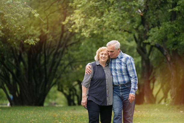 istock Senior couple walking in the park 1311243159