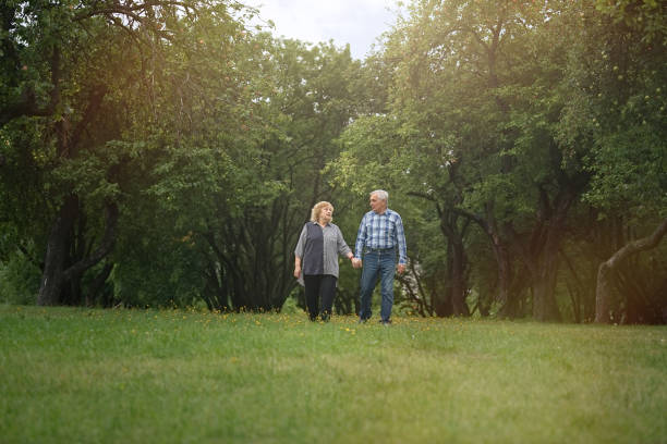 istock Senior couple walking in the park 1311243163