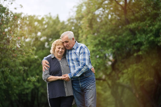 istock Senior couple walking in the park 1311243164