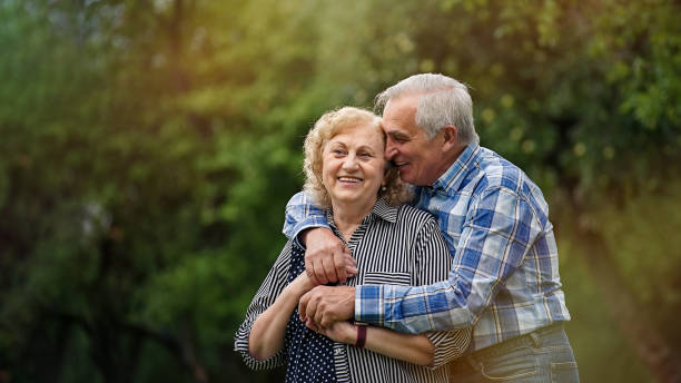 istock Senior couple walking in the park 1311243176