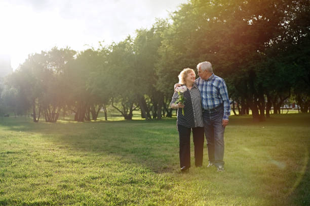 istock Senior couple walking in the park 1311243180