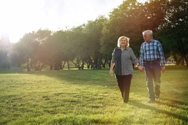 istock Senior couple walking in the park 1311243188