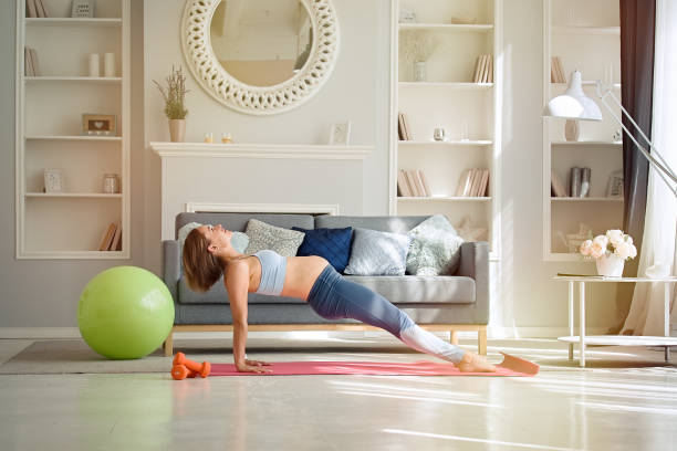 istock Pregnant woman exercising at home 1311243304