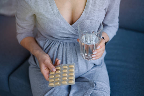 istock Pregnant woman taking medicine 1311243357