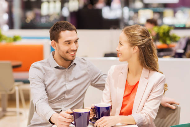 istock happy couple with shopping bags drinking coffee 1311244555