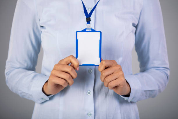 istock Woman holding Identification white blank plastic id card 1311244798