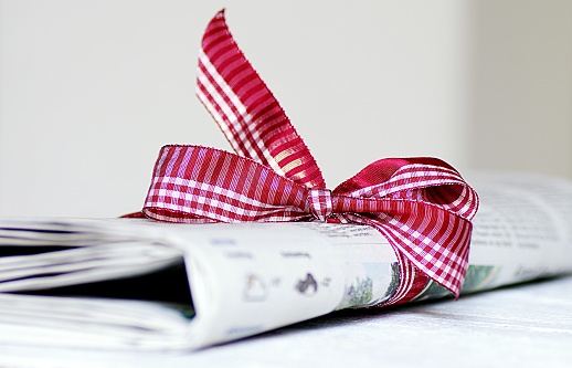 Daily newspaper with red checkered bow