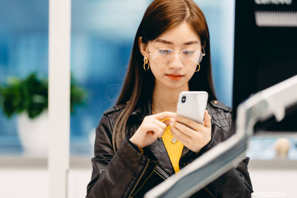 istock Professional Asian businesswoman working hard. Using smart phone. 1311248680
