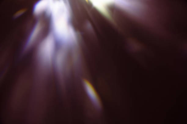 Blur colorful warm rainbow light leaks on black background with dust texture. Defocused abstract damaged scratched retro film analog effect for using over photos as overlay or screen filter