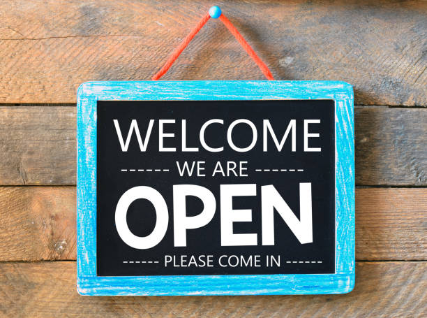 istock Welcome we are open words written on a chalkboard. 1311250927