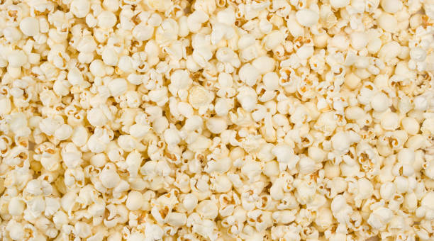 istock Scattered salted popcorn background macro shot 1311252557