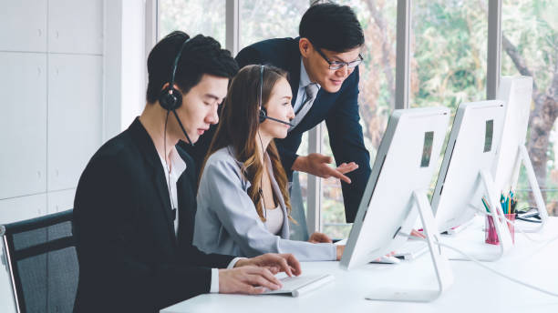 istock Business people wearing headset working in office 1311252794
