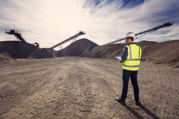 istock Back view of inspector at open-pit mine 1311253947