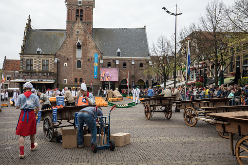 Alkmaar, Netherlands - April 21, 2017: Typical cheese market in the city of Alkmaar in Netherlands, one of the only four traditional Dutch cheese markets still in existence and one of the country's most popular tourist attractions.