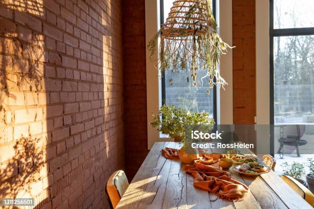 Dining Place With A Wooden Table Stock Photo - Download Image Now - Apartment, Brick, Brick Wall