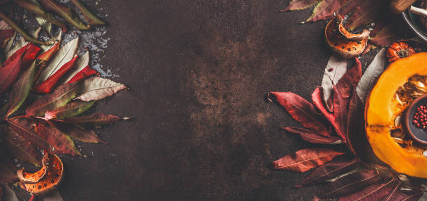 istock Autumn border background with half pumpkin and fall leaves. 1311256722
