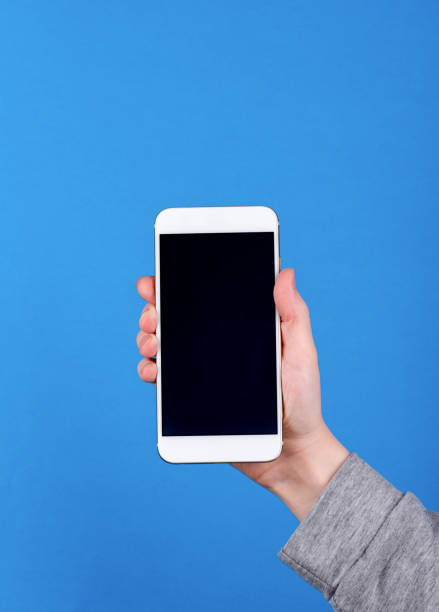 istock Close up woman's hand hold smartphone with black blank screen. 1311257884
