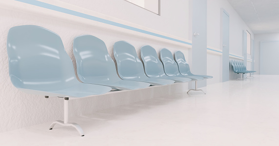 waiting chairs in a hospital corridor with blurred background. 3d rendering