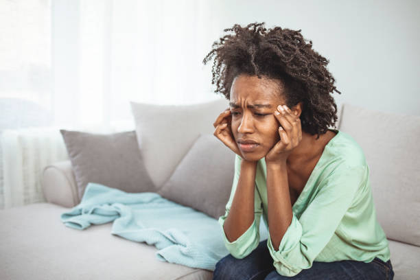 istock African woman sitting on couch feels unhappy having problems 1311259784