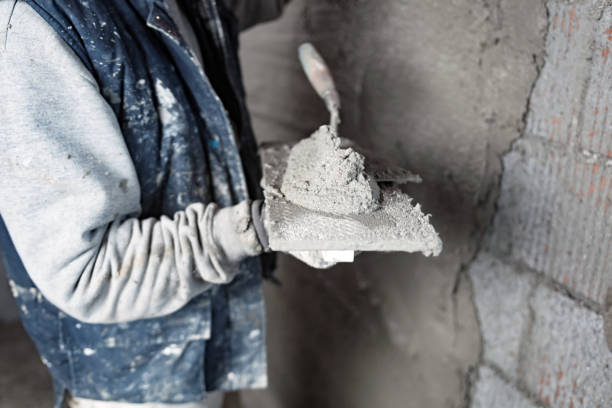 istock Real construction worker working on a wall inside the new house. 1311261286
