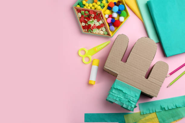 istock Cardboard cactus and materials on pink background, flat lay with space for text. Pinata DIY 1311261782