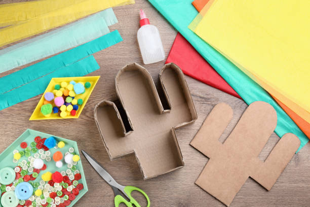Materials and tools on wooden table, flat lay. Cactus pinata DIY