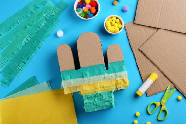 istock Cardboard cactus and materials on light blue background, flat lay. Pinata DIY 1311261878