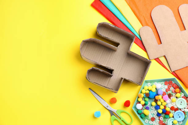 istock Materials and tools on yellow background, flat lay with space for text. Cactus pinata DIY 1311261897