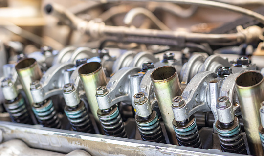 The mechanic is checking the engine.