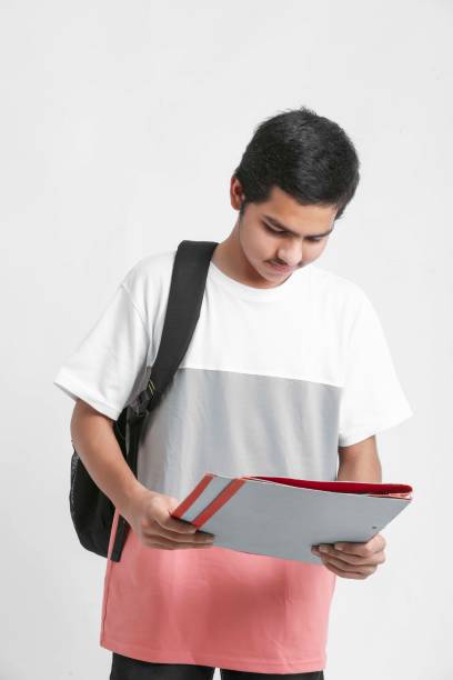 istock College Boy holding with file in hand on white background. 1311265143