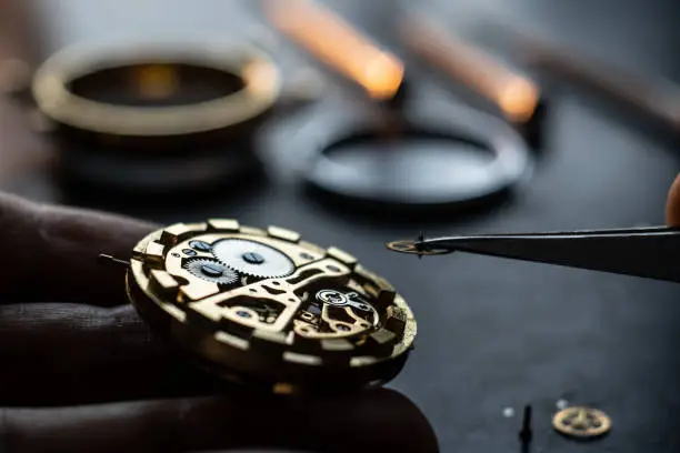 Mechanical watch repair process. Open pocket wristwatch. Doing precise job. Craftsman. Watchmaker adjust watch. Precise occupation. High accuray level