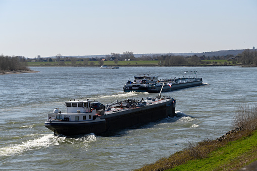 Xanten, Germany, March 29, 2021 - Busy shipping traffic on the Rhine near Rees on the Lower Rhine