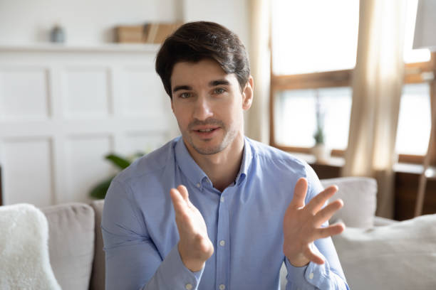 istock Head shot portrait confident man speaking at camera, video call 1311267383