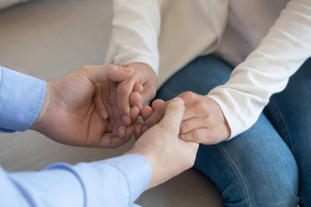 istock Close up loving husband holding wife hands, supporting and comforting 1311267406