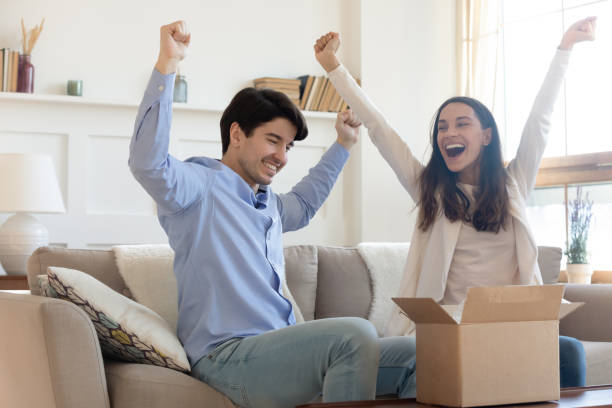 istock Overjoyed man and woman unpacking awaited parcel, celebrating success 1311267417
