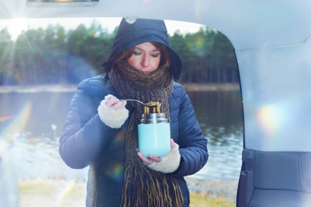 istock Woman is eating a hot dish from a thermos 1311269462