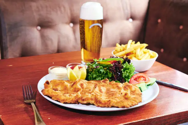 Veal schnitzel with salad and french fries Schnitzel of veal meat