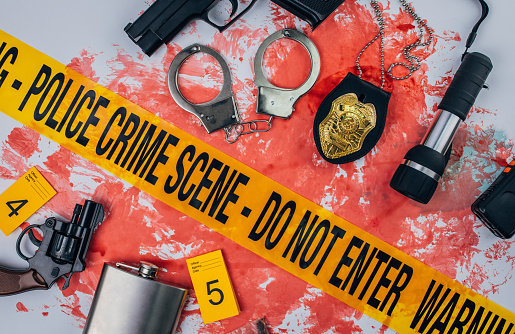 Crime scene tape and crime evidence over blood stain. Flat lay concept.