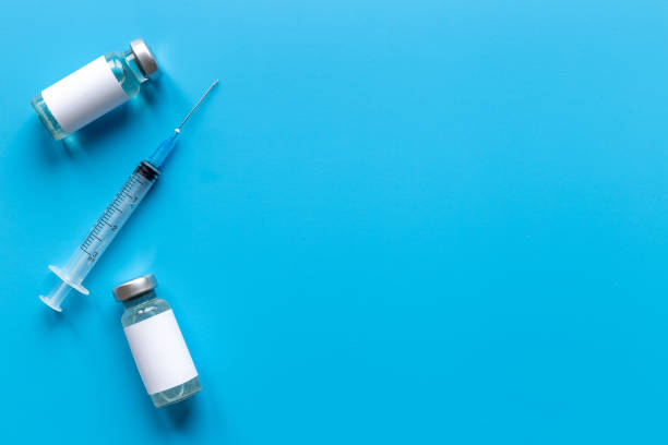 istock Coronavirus vaccine ampoules with syringe. Vaccination concept 1311270717