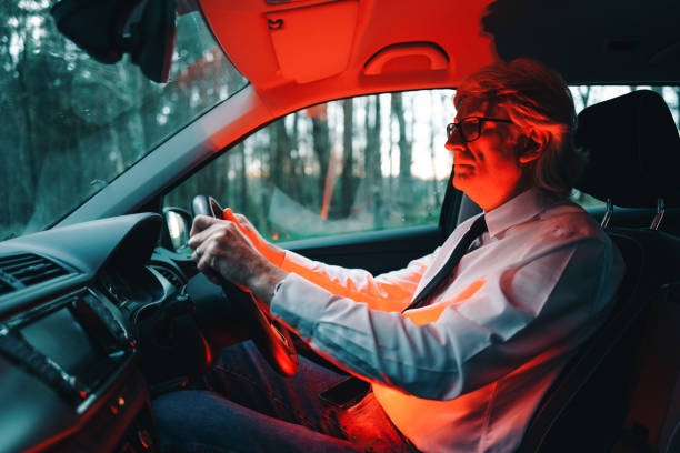 istock Mysterious man in illuminated car interior 1311272286
