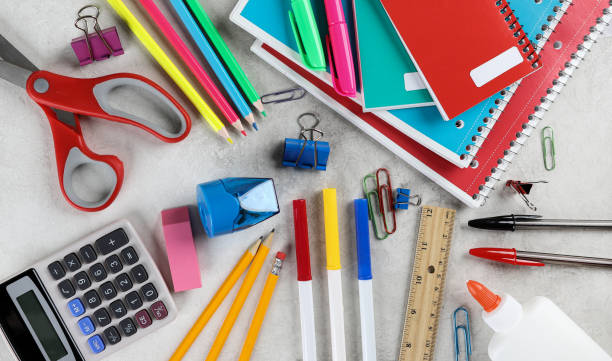 Assortment of School Supplies on a Table Overhead view of an assortment of school supplies on a table school supplies stock pictures, royalty-free photos & images
