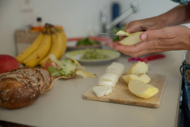 istock Woman makes healthy salad, she cuts the apple 1311273982