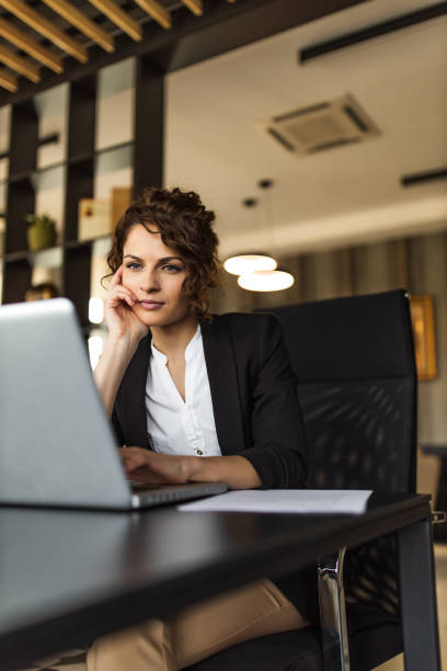 istock Business manager reading report on laptop, portrait. 1311274030