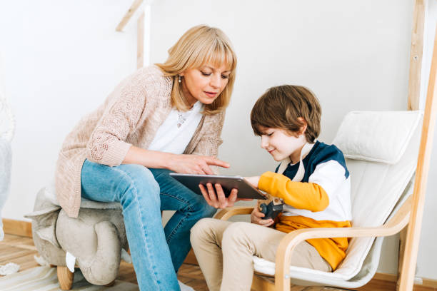 istock Mother with son in children's room, looking at tablet 1311275593