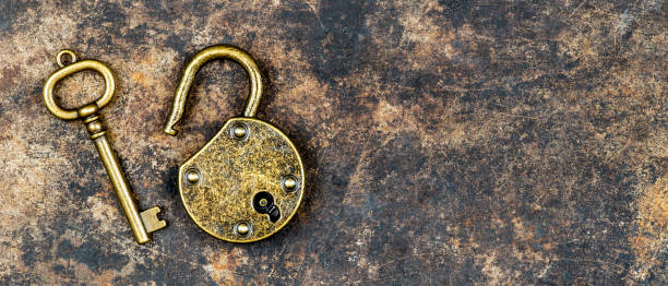 istock Escape room game concept old vintage key on and padlock 1311277658