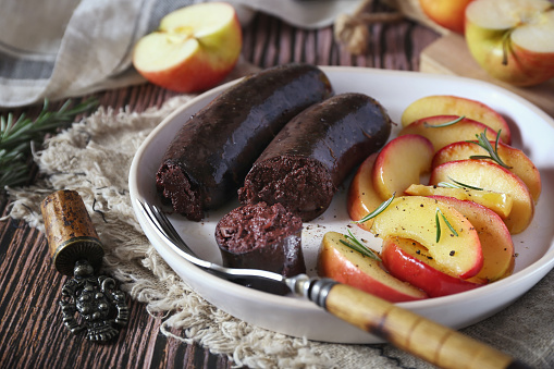 Traditional French cuisine: fried blood sausage and apples