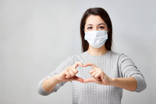 istock Young woman showing heart symbol shape with hands 1311281459