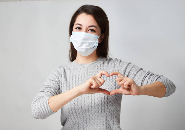 istock Young woman showing heart symbol shape with hands 1311281468
