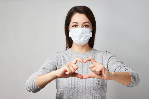istock Young woman showing heart symbol shape with hands 1311281471